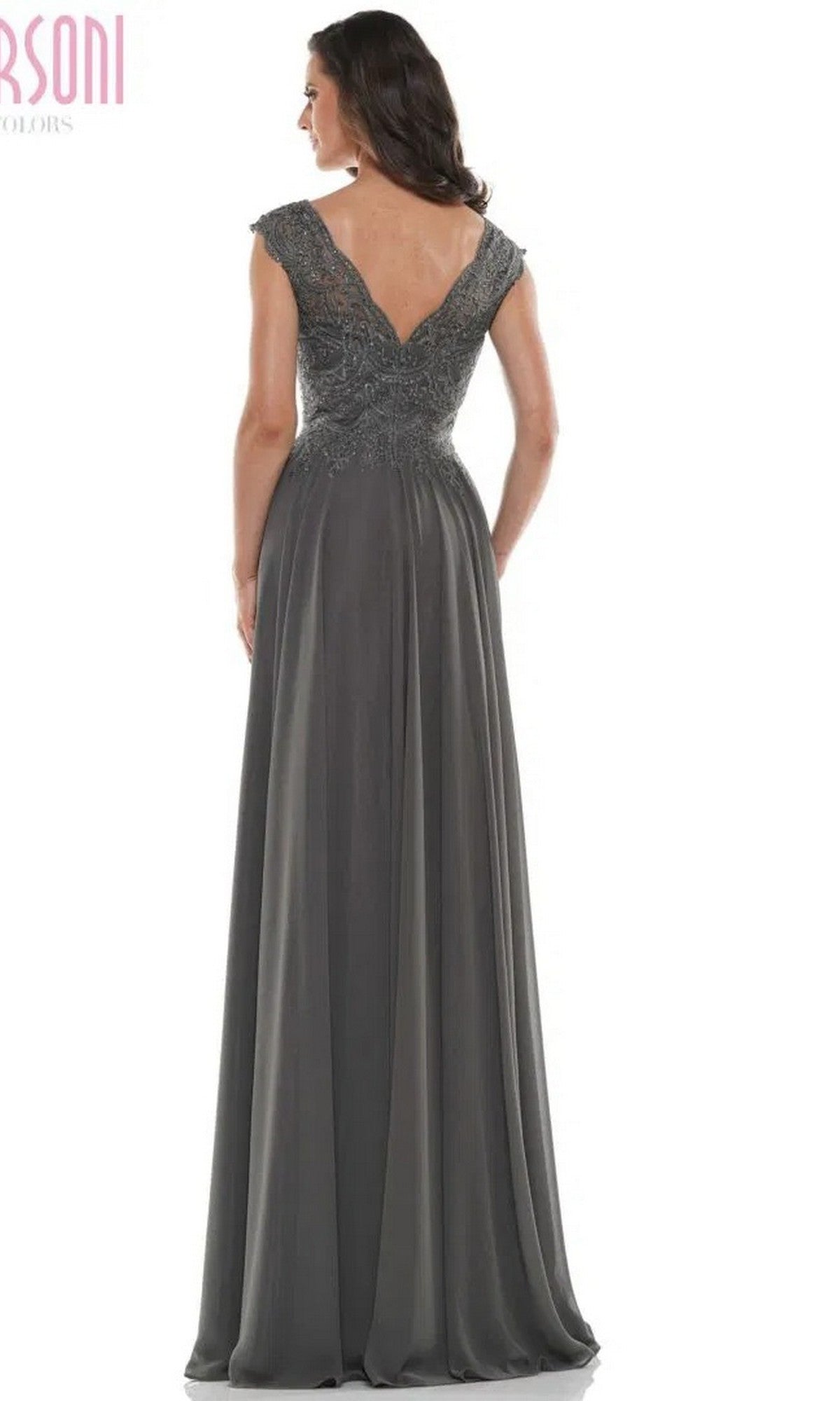 Woman in the Marsoni M238 long formal dress, featuring a floor-length dark gray design with an embroidered bodice and lace-detailed fitted cap sleeves, shown from the back.